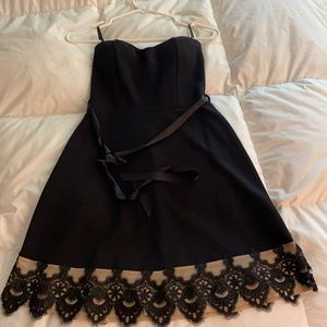 Sleeveless black dress with lace on the bottom